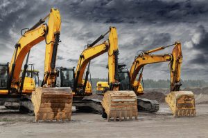 powerful-excavators-construction-site-against-blue-cloudy-sky-earthmoving-construction-equipment-lots-excavators